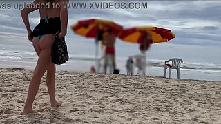 Milf holds my penis tightly in her hand until I cum right on the beach