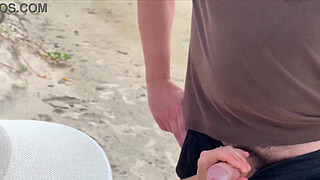 Milf holds my penis tightly in her hand until I cum right on the beach