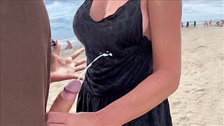 Milf holds my penis tightly in her hand until I cum right on the beach