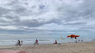 Milf holds my penis tightly in her hand until I cum right on the beach