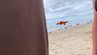 Milf holds my penis tightly in her hand until I cum right on the beach