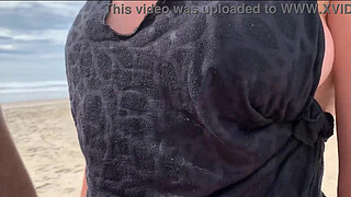 Milf holds my penis tightly in her hand until I cum right on the beach