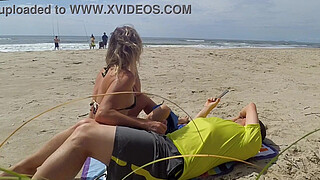 Milf makes stranger ejaculate with skillful handjob right on the beach