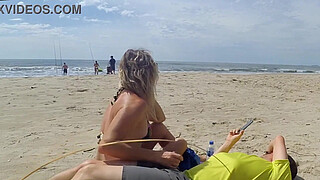 Milf makes stranger ejaculate with skillful handjob right on the beach
