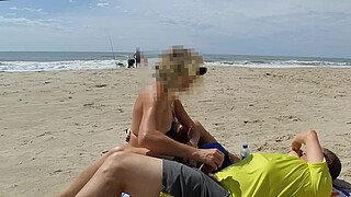 Milf makes stranger ejaculate with skillful handjob right on the beach