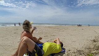 Milf makes stranger ejaculate with skillful handjob right on the beach