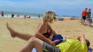 Milf makes stranger ejaculate with skillful handjob right on the beach