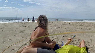 Milf makes stranger ejaculate with skillful handjob right on the beach