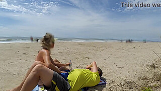 Milf makes stranger ejaculate with skillful handjob right on the beach