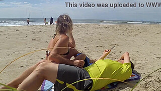 Milf makes stranger ejaculate with skillful handjob right on the beach