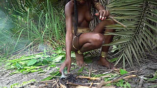 Hot African native woman cooking in the jungle