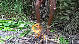 Hot African native woman cooking in the jungle