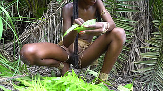 Hot African native woman cooking in the jungle