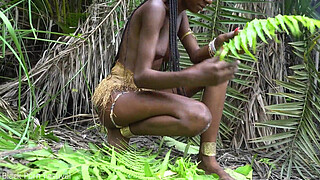 Hot African native woman cooking in the jungle