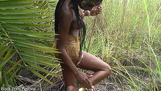 Hot African native woman cooking in the jungle