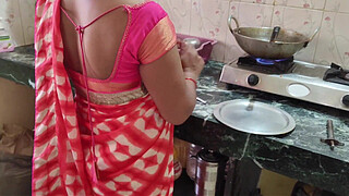 Desi Bhabhi was working in the kitchen when the servant fucked her