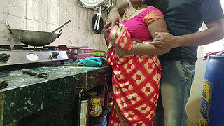 Desi Bhabhi was working in the kitchen when the servant fucked her