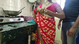 Desi Bhabhi was working in the kitchen when the servant fucked her