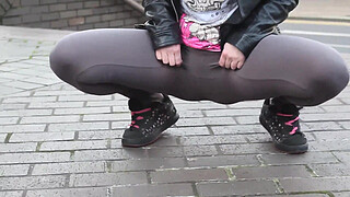 Beautiful and very slutty whore shows her butt in public while pissing between her legs