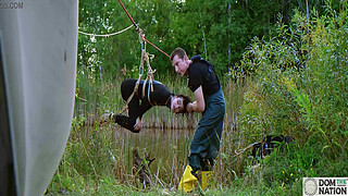 Submissive painslut softened up for painal punishment with some dunks in the pond - Lydia Black and Charlotte Sartre in a real outdoor BDSM sex documentary filmed in Wisconsin