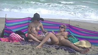 Exhibitionist Wife 484 Part 5 - Mrs Ginary and Mrs Nikki Brooks Teasing Nude Beach Voyeur! Spreading legs and teasing cocks in public!