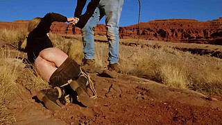 Big-butt blonde gets her anus whipped, then gets rough anal sex in dirt and piss -- a real BDSM session outdoors in the Western USA with Rebel Rhyder