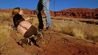 Big-butt blonde gets her anus whipped, then gets rough anal sex in dirt and piss -- a real BDSM session outdoors in the Western USA with Rebel Rhyder