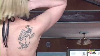 An attractive individual with tattoos entices her neighbor to engage in sexual activity with her.