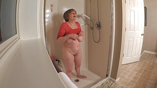 60 GILF masturbating in wet t-shirt