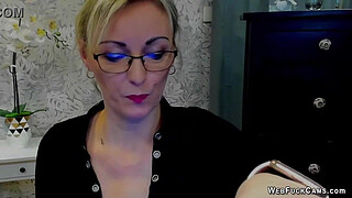 Blonde amateur German MILF LUXvanessa in mini skirt and black blouse with big cleavage flashing boobs on solo webcam show