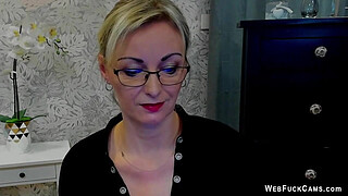 Blonde amateur MILF takes off bra under blouse on webcam