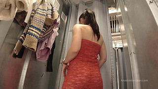 I try on clothes in fitting room with open curtain.