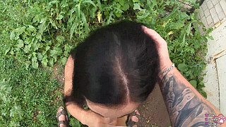 Horny student gives blowjob behind garages