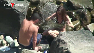 Beach Voyeur. Horny teen chick rides her boyfriend on the beach