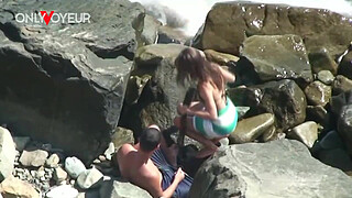 Beach Voyeur. Horny teen chick rides her boyfriend on the beach