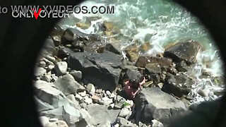 Beach Voyeur. Horny teen chick rides her boyfriend on the beach