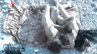 Beach Voyeur. Hot girl with big natural tits gives head on a public beach