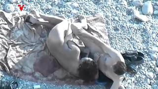 Beach Voyeur. Hot girl with big natural tits gives head on a public beach